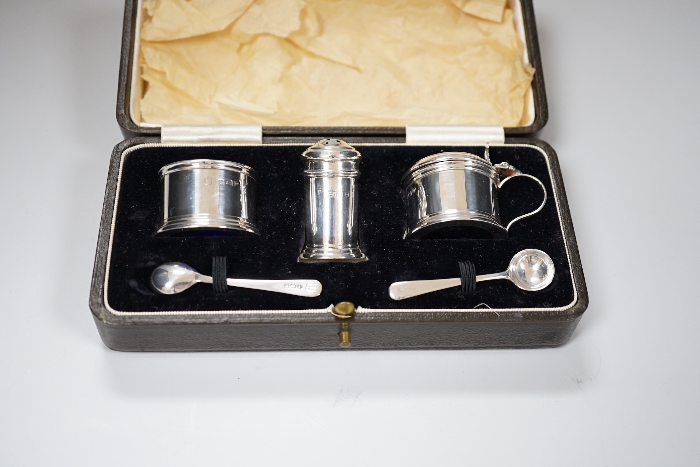 A George VI cased silver three piece condiment set and two spoons, Birmingham 1939